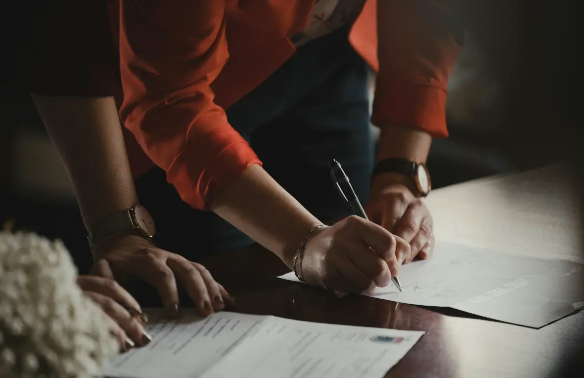 a person is signing a document